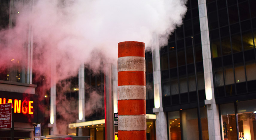 Steam coming out of a construction pipe on the streets of New York 